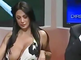 Famous Italian TV host with large boobs desperately tries to keep them in her dress
